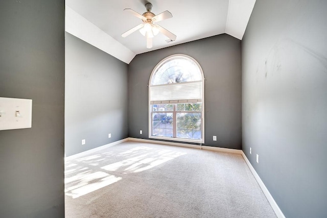 carpeted empty room with ceiling fan and lofted ceiling