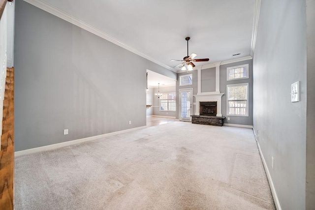 unfurnished living room with light carpet, a fireplace, ornamental molding, and ceiling fan