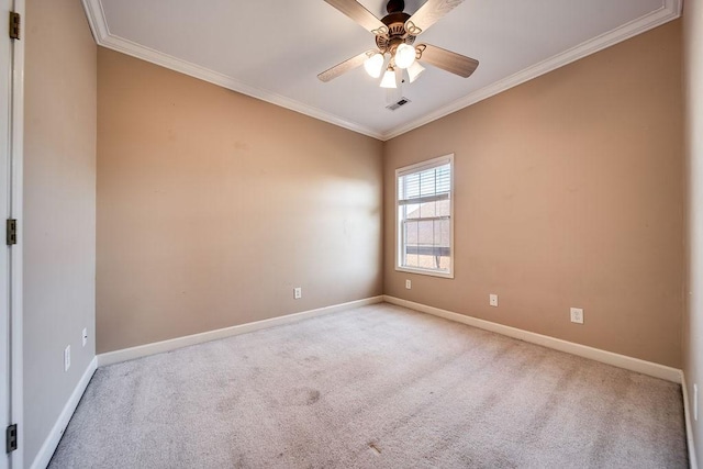 carpeted spare room featuring ceiling fan and ornamental molding