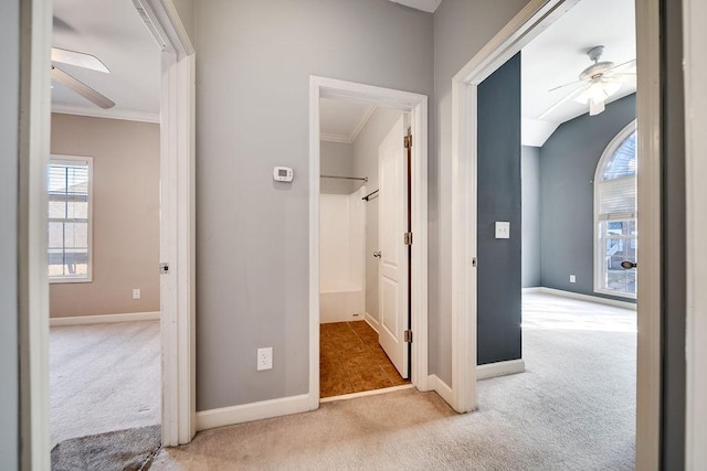 hall featuring light carpet and ornamental molding