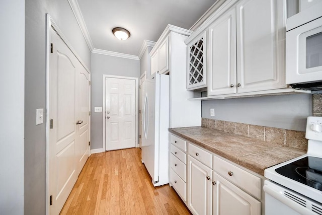 kitchen featuring tile countertops, light hardwood / wood-style floors, white appliances, white cabinets, and ornamental molding