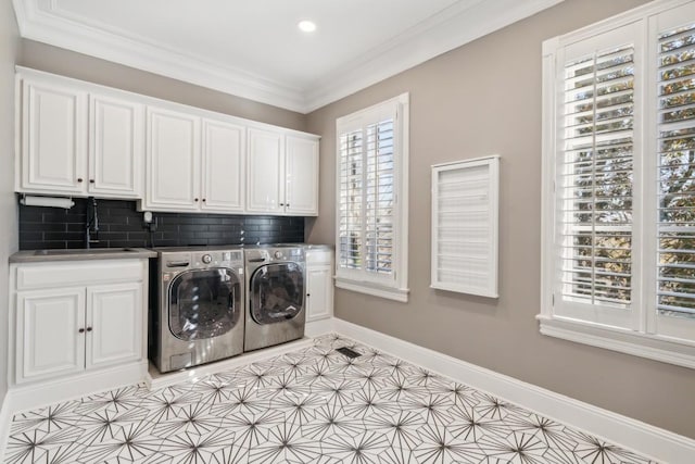 laundry room featuring cabinets, washer and dryer, crown molding, sink, and light tile patterned flooring