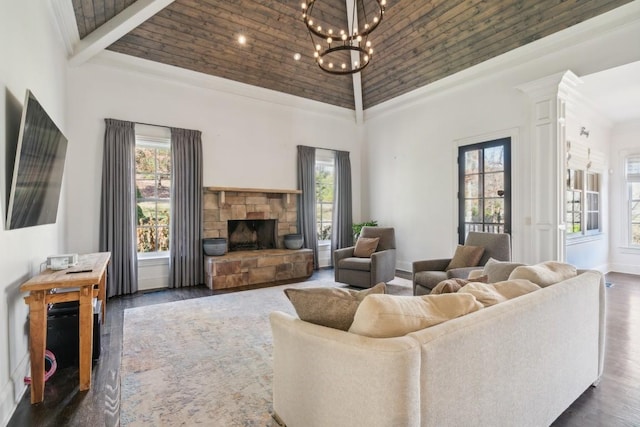 living room with wooden ceiling, a notable chandelier, dark hardwood / wood-style flooring, high vaulted ceiling, and a fireplace