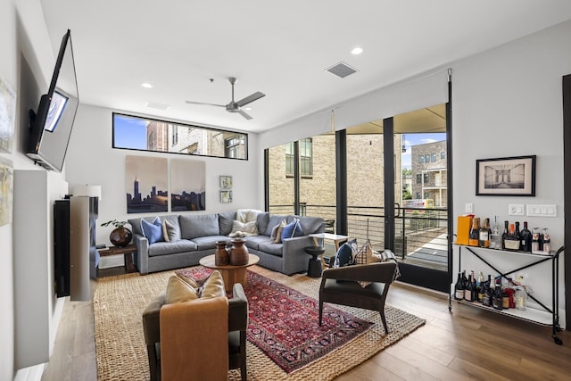 living room with ceiling fan and hardwood / wood-style floors