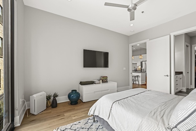 bedroom featuring ceiling fan, stainless steel fridge with ice dispenser, and light hardwood / wood-style flooring