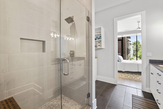 bathroom with tile patterned flooring, vanity, and a shower with shower door