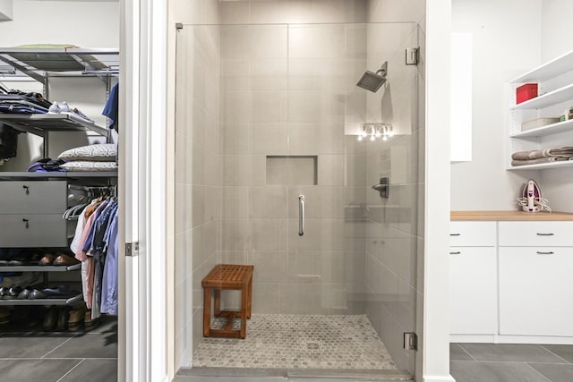 bathroom with tile patterned floors and walk in shower