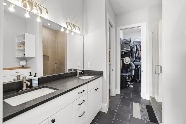 bathroom featuring tile patterned floors, vanity, and an enclosed shower