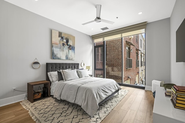 bedroom with ceiling fan and light hardwood / wood-style flooring