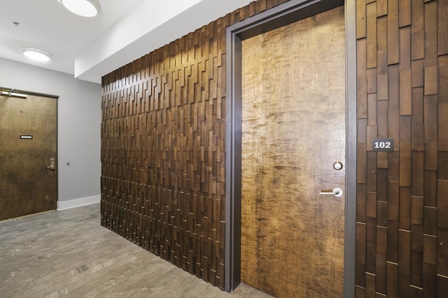 hall with hardwood / wood-style floors