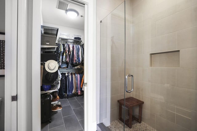 bathroom with tile patterned floors and an enclosed shower