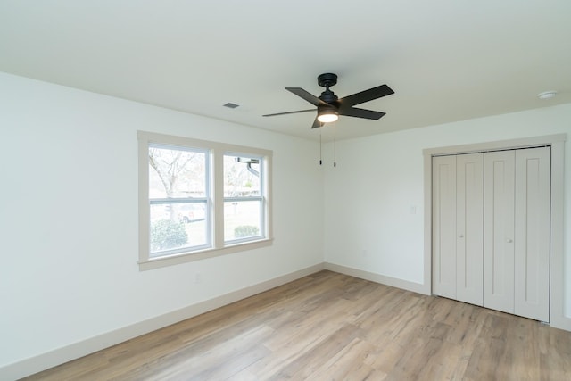 unfurnished bedroom with a closet, ceiling fan, and light hardwood / wood-style flooring