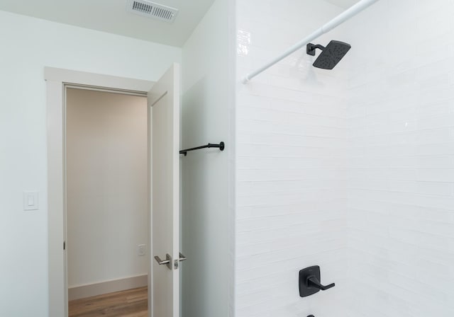 bathroom with shower / bathing tub combination and wood-type flooring