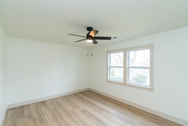 empty room with ceiling fan and light wood-type flooring