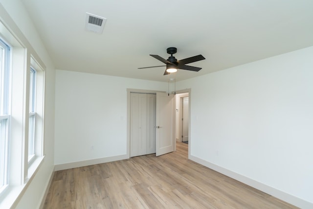 unfurnished room with ceiling fan and light hardwood / wood-style floors