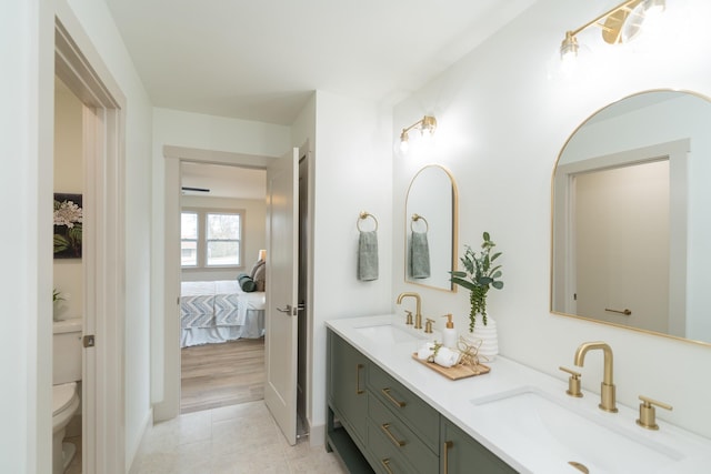 bathroom featuring toilet, vanity, and hardwood / wood-style flooring