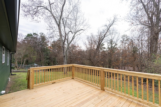 wooden terrace featuring a lawn