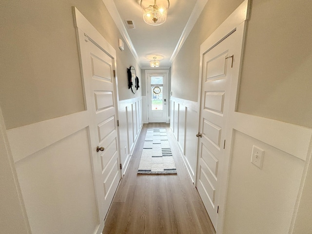 hallway featuring crown molding and dark hardwood / wood-style flooring