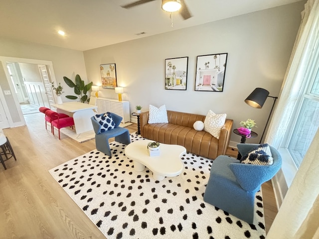 living room with ceiling fan and light hardwood / wood-style floors