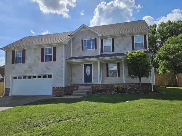 front of property with a front yard and a garage