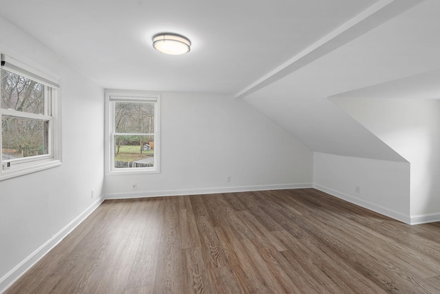 additional living space featuring dark hardwood / wood-style flooring and vaulted ceiling