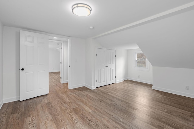 bonus room featuring hardwood / wood-style flooring and vaulted ceiling