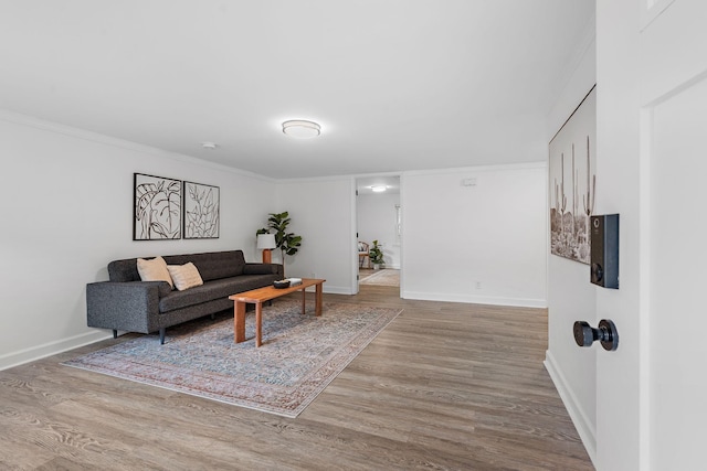 living room with hardwood / wood-style flooring and ornamental molding