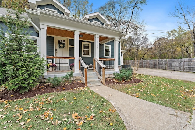 doorway to property with a yard and a porch