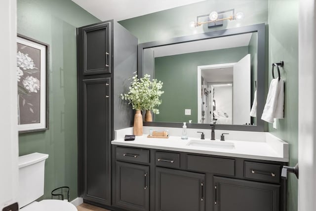 bathroom featuring vanity and toilet