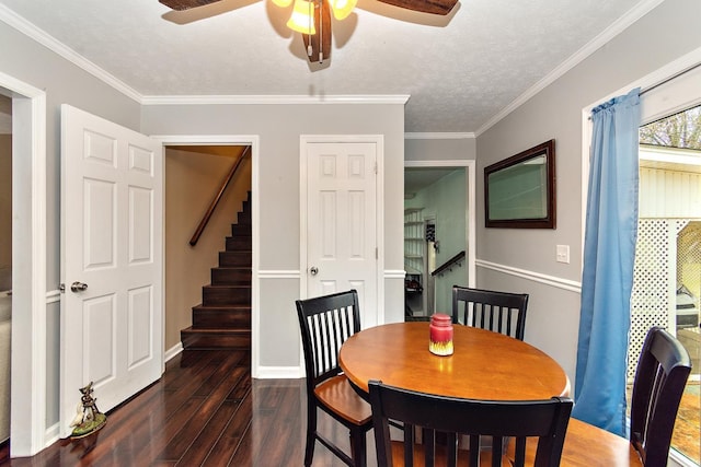 dining space featuring a textured ceiling, dark hardwood / wood-style flooring, ceiling fan, and ornamental molding