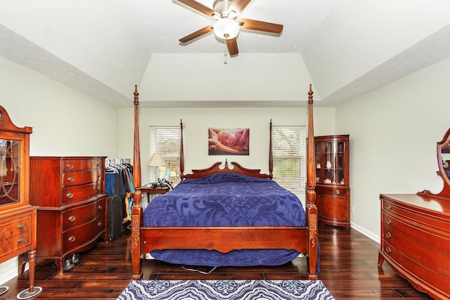 bedroom featuring dark hardwood / wood-style floors, ceiling fan, and vaulted ceiling