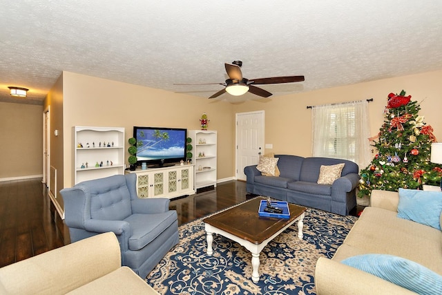 living room with ceiling fan, hardwood / wood-style floors, and a textured ceiling