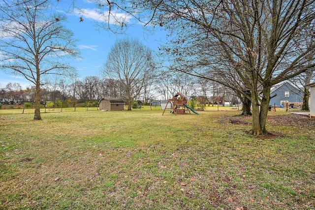 view of yard with a playground and a storage unit