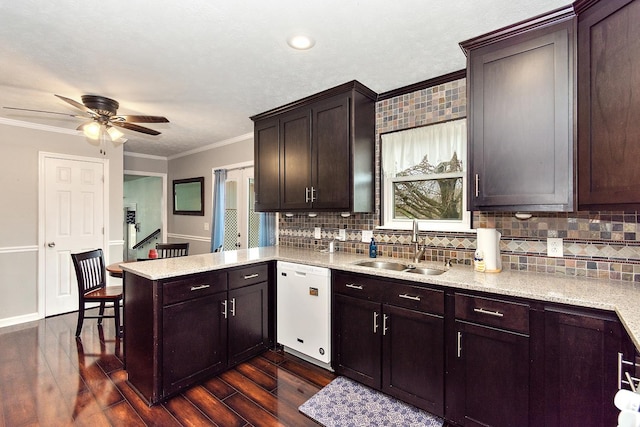 kitchen featuring dishwasher, dark hardwood / wood-style floors, ornamental molding, dark brown cabinets, and kitchen peninsula