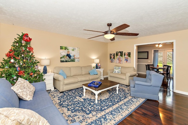 living room featuring a textured ceiling and dark wood-type flooring