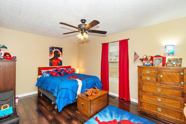 bedroom with a textured ceiling, dark hardwood / wood-style floors, and ceiling fan