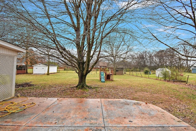 view of yard with a patio, a playground, and a shed