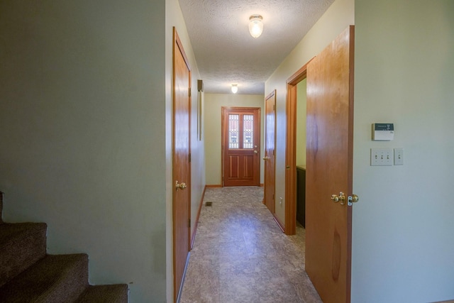 hallway featuring a textured ceiling