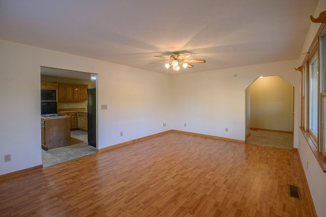 unfurnished living room with light hardwood / wood-style floors and ceiling fan