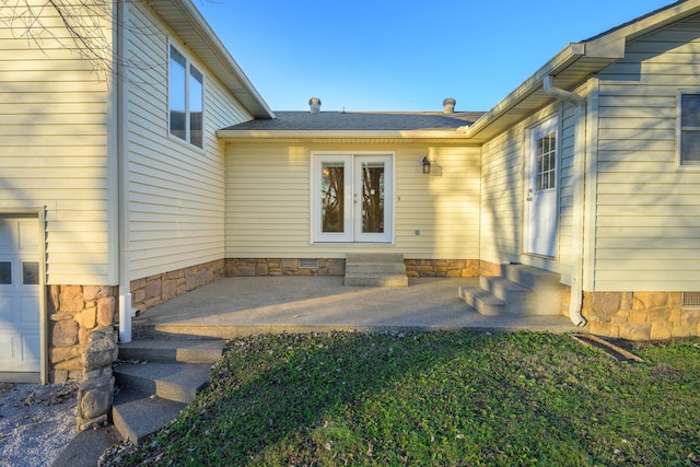 view of exterior entry with french doors and a patio