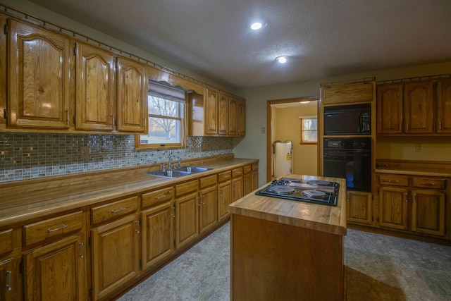 kitchen featuring backsplash, wooden counters, black appliances, sink, and a kitchen island