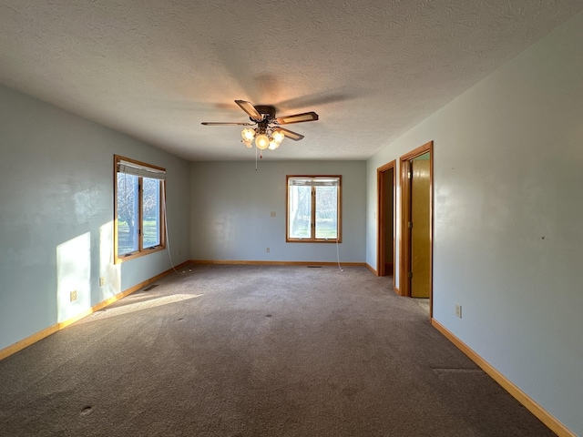 spare room featuring light carpet, a textured ceiling, and ceiling fan