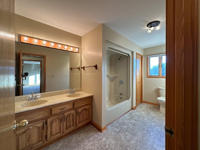 full bathroom featuring vanity, a textured ceiling, toilet, and shower / bathtub combination