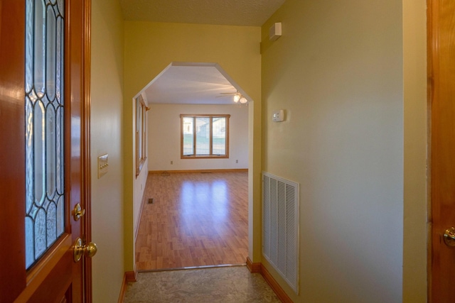 hallway with light hardwood / wood-style floors