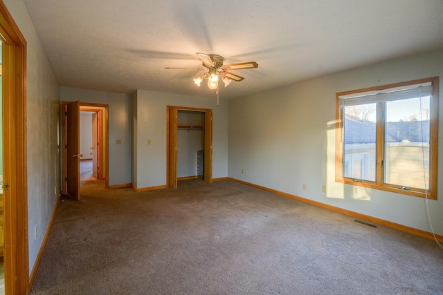 unfurnished bedroom featuring carpet, a closet, and ceiling fan