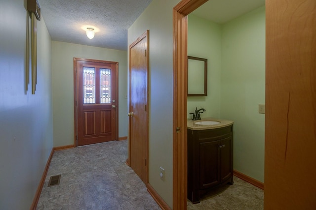 entryway with a textured ceiling and sink