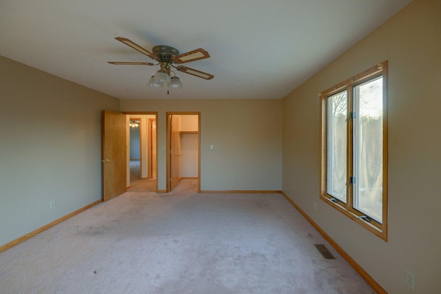 carpeted spare room with ceiling fan