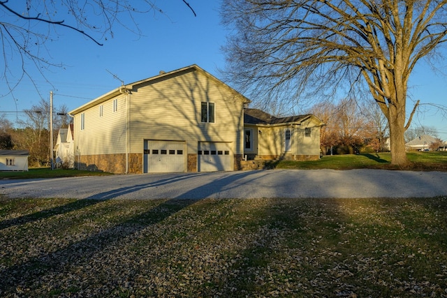 view of home's exterior featuring a lawn and a garage