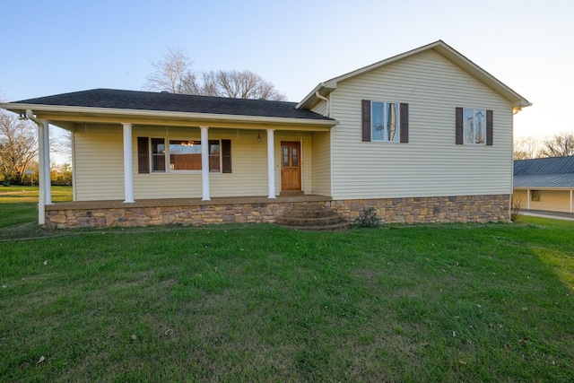 tri-level home with a porch and a front lawn