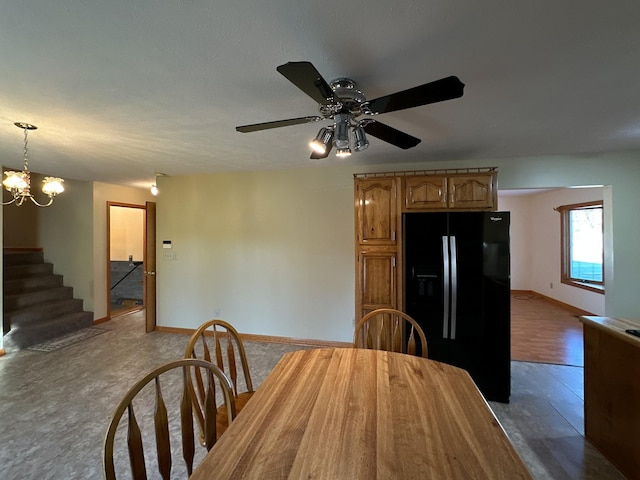 unfurnished dining area with ceiling fan with notable chandelier and a textured ceiling